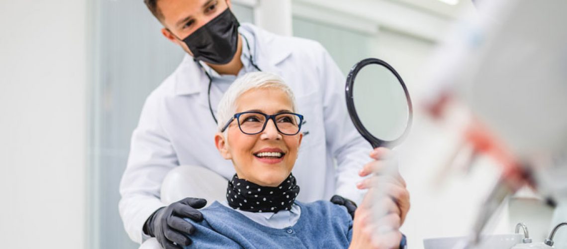 a dental patient smiling after dental implant surgery